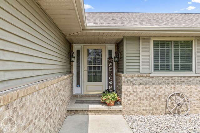 7360 Frith Rd, Saint Clair, MI 48079 - view of exterior entry featuring brick siding and a shingled roof