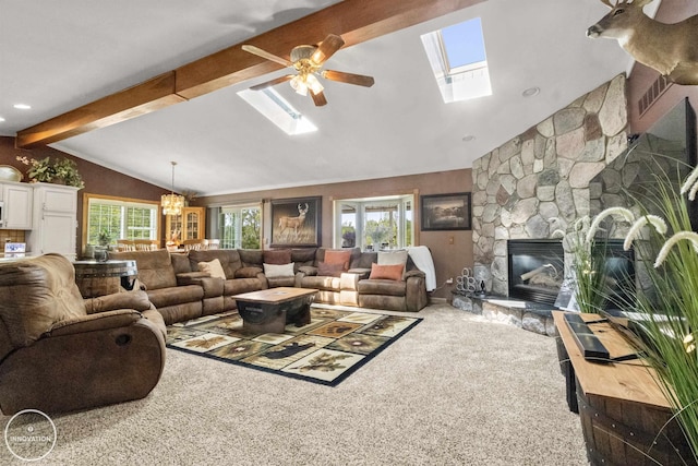 7360 Frith Rd, Saint Clair, MI 48079 - carpeted living room featuring a skylight, a ceiling fan, a stone fireplace, and a chandelier