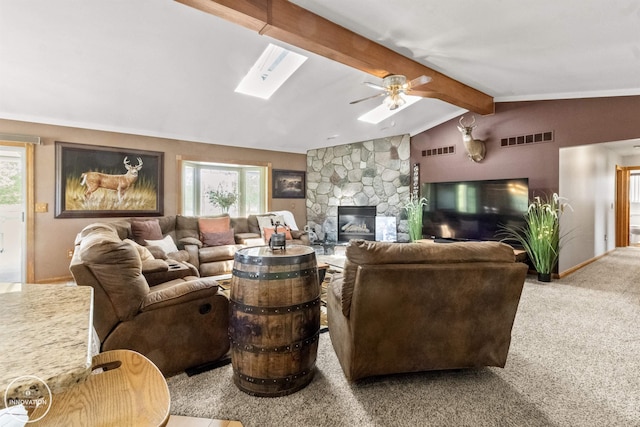 7360 Frith Rd, Saint Clair, MI 48079 - carpeted living room with a stone fireplace, ceiling fan, a skylight, and baseboards