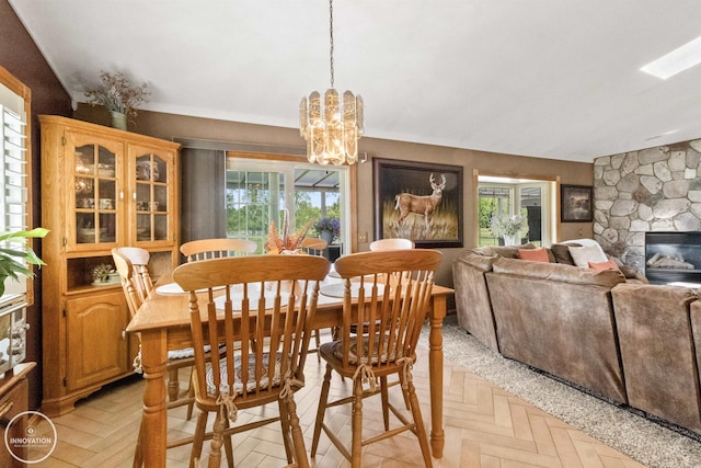 7360 Frith Rd, Saint Clair, MI 48079 - dining room featuring a chandelier and a stone fireplace