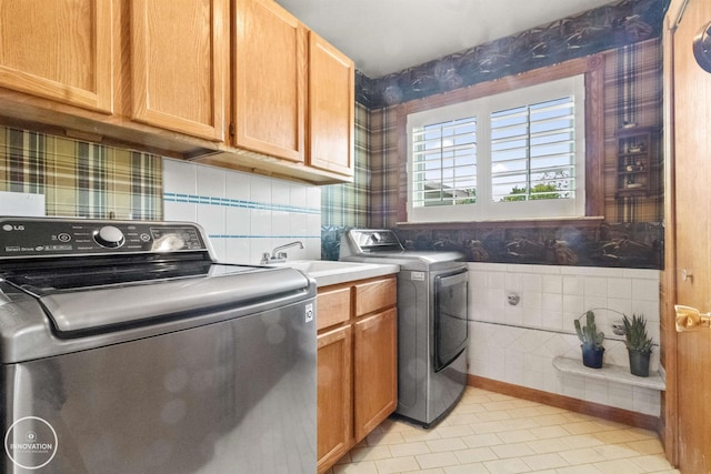 7360 Frith Rd, Saint Clair, MI 48079 - laundry area with cabinet space, washer and dryer, wallpapered walls, and light tile patterned floors