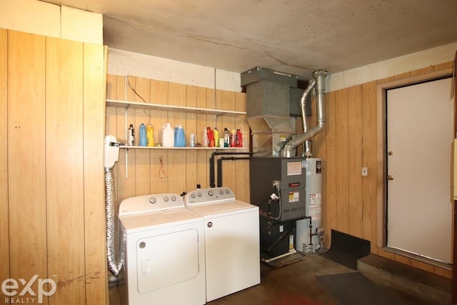 2940 Westland Dr, Port Huron, MI 48060 - washroom with washer and dryer, wooden walls, gas water heater, and heating unit