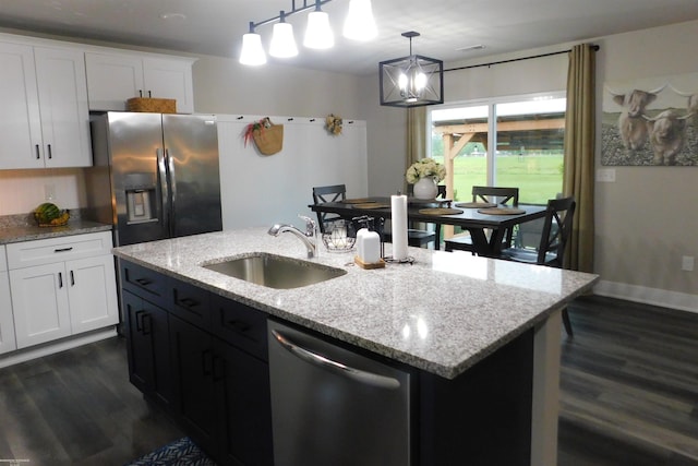 80367 Belle River Rd, Memphis, MI 48041 - kitchen featuring appliances with stainless steel finishes, a sink, dark wood finished floors, white cabinets, and decorative light fixtures