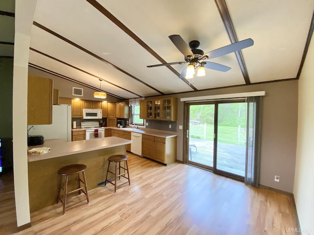 47275 Green Acres Rd, Houghton, MI 49931 - kitchen featuring white appliances, a peninsula, light wood-style floors, and a kitchen breakfast bar