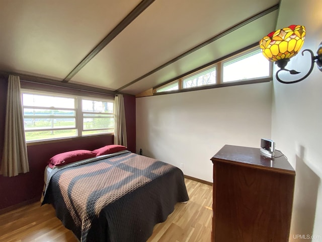 47275 Green Acres Rd, Houghton, MI 49931 - bedroom with lofted ceiling, light wood-type flooring, and baseboards
