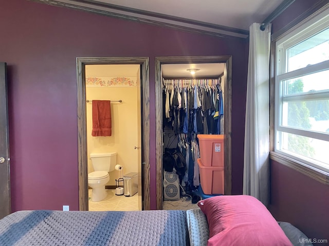 47275 Green Acres Rd, Houghton, MI 49931 - bedroom featuring a closet, multiple windows, crown molding, a walk in closet, and baseboards
