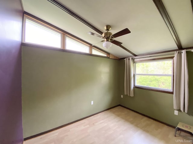 47275 Green Acres Rd, Houghton, MI 49931 - spare room with vaulted ceiling, ceiling fan, light wood-type flooring, and baseboards