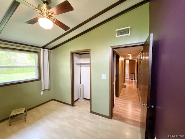 47275 Green Acres Rd, Houghton, MI 49931 - unfurnished bedroom featuring vaulted ceiling, baseboards, light wood-style flooring, and ceiling fan