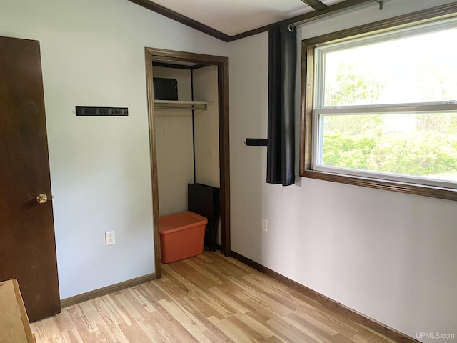 47275 Green Acres Rd, Houghton, MI 49931 - unfurnished bedroom featuring light wood-type flooring, a closet, baseboards, and crown molding