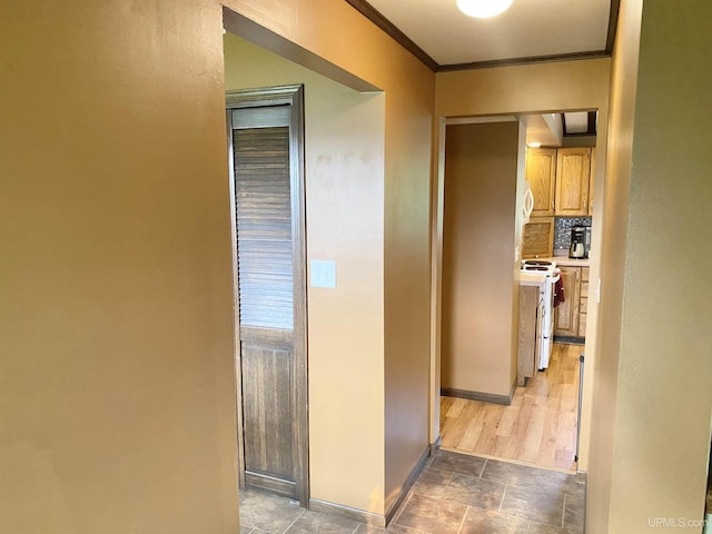 47275 Green Acres Rd, Houghton, MI 49931 - corridor featuring stone finish flooring, crown molding, and baseboards