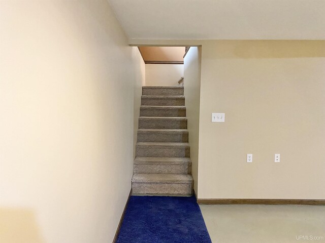 47275 Green Acres Rd, Houghton, MI 49931 - stairway featuring finished concrete flooring and baseboards