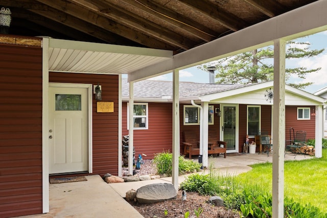 3394 E Pinecrest St, Gladwin, MI 48624 - doorway to property featuring roof with shingles and a patio area