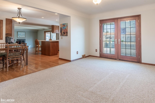 38044 Seaway Ct, Harrison Twp, MI 48045 - dining room featuring light colored carpet, healthy amount of natural light, baseboards, and light wood finished floors