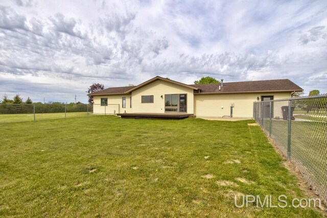 12104 T Rd, Rapid River, MI 49878 - back of property with a wooden deck