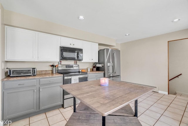 3365 Hickory Ln, Port Huron, MI 48060 - kitchen featuring stainless steel appliances, light tile patterned floors, a baseboard radiator, recessed lighting, and light countertops