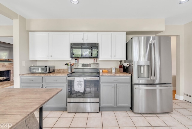 3365 Hickory Ln, Port Huron, MI 48060 - kitchen with stainless steel appliances, light countertops, light tile patterned floors, white cabinetry, and recessed lighting