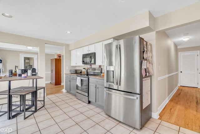 3365 Hickory Ln, Port Huron, MI 48060 - kitchen featuring appliances with stainless steel finishes, light tile patterned floors, light countertops, baseboards, and recessed lighting