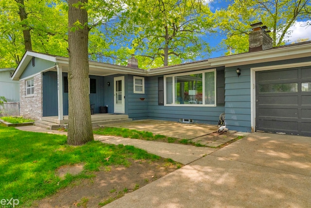 3365 Hickory Ln, Port Huron, MI 48060 - ranch-style home featuring a chimney, driveway, and an attached garage