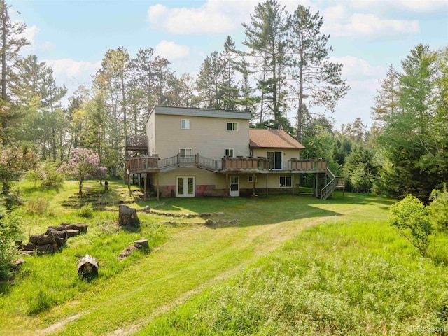 4427 Tip Up Trl, Eagle River, WI 54521 - back of property with a wooden deck, a lawn, french doors, and stairway