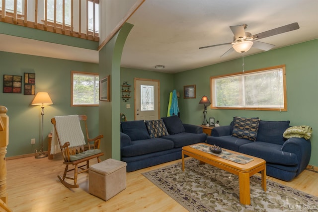4427 Tip Up Trl, Eagle River, WI 54521 - living room featuring wood finished floors, arched walkways, ceiling fan, and baseboards