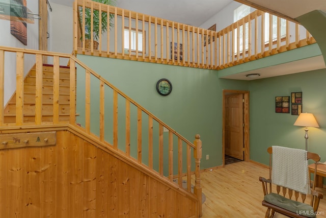 4427 Tip Up Trl, Eagle River, WI 54521 - stairway with a towering ceiling, wood finished floors, and baseboards