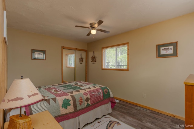 4427 Tip Up Trl, Eagle River, WI 54521 - bedroom with wood finished floors, baseboards, a closet, and ceiling fan