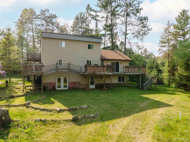 4427 Tip Up Trl, Eagle River, WI 54521 - back of house featuring french doors, a wooden deck, and a yard