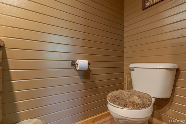 4427 Tip Up Trl, Eagle River, WI 54521 - bathroom with wooden walls, toilet, and wood finished floors