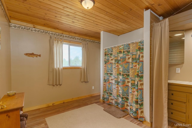 4427 Tip Up Trl, Eagle River, WI 54521 - full bath with wood ceiling, wood finished floors, and baseboards
