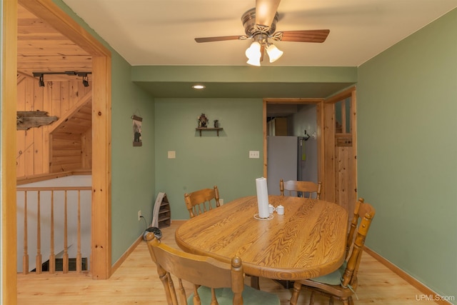 4427 Tip Up Trl, Eagle River, WI 54521 - dining room with light wood-style flooring, ceiling fan, and baseboards