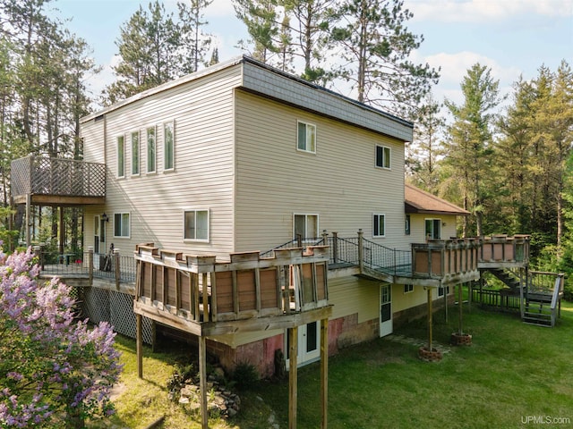 4427 Tip Up Trl, Eagle River, WI 54521 - back of property with a yard and a deck