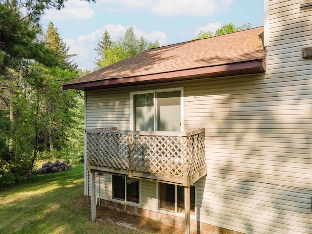 4427 Tip Up Trl, Eagle River, WI 54521 - rear view of property featuring a shingled roof and a yard