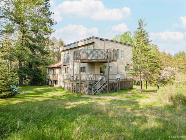 4427 Tip Up Trl, Eagle River, WI 54521 - rear view of house featuring a deck, stairs, and a yard