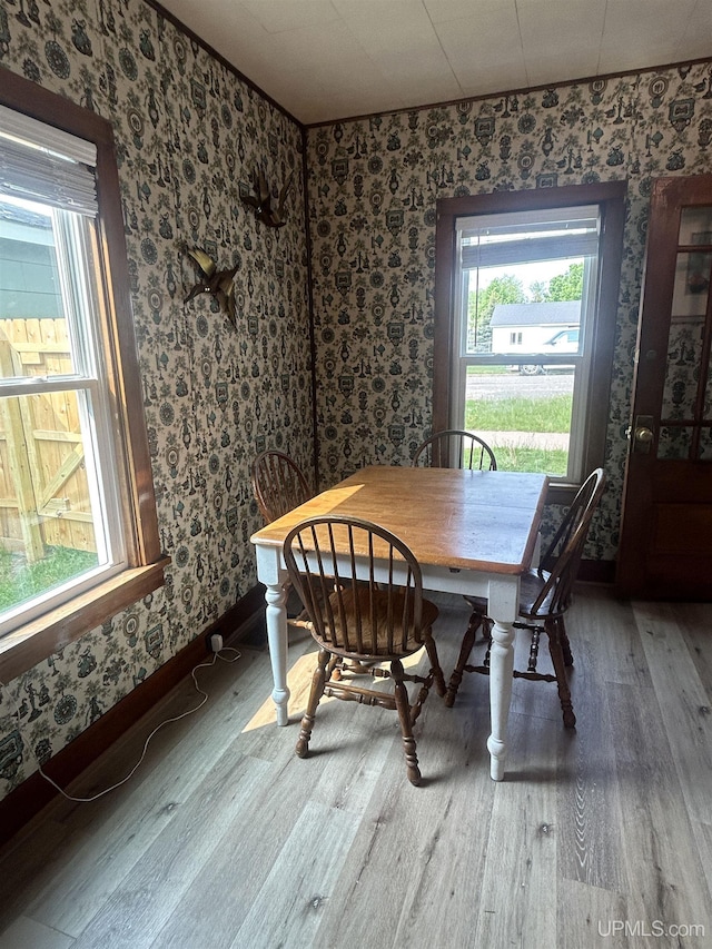 312 N Mckenzie Ave, Negaunee, MI 49866 - dining room featuring wallpapered walls, wood finished floors, and baseboards