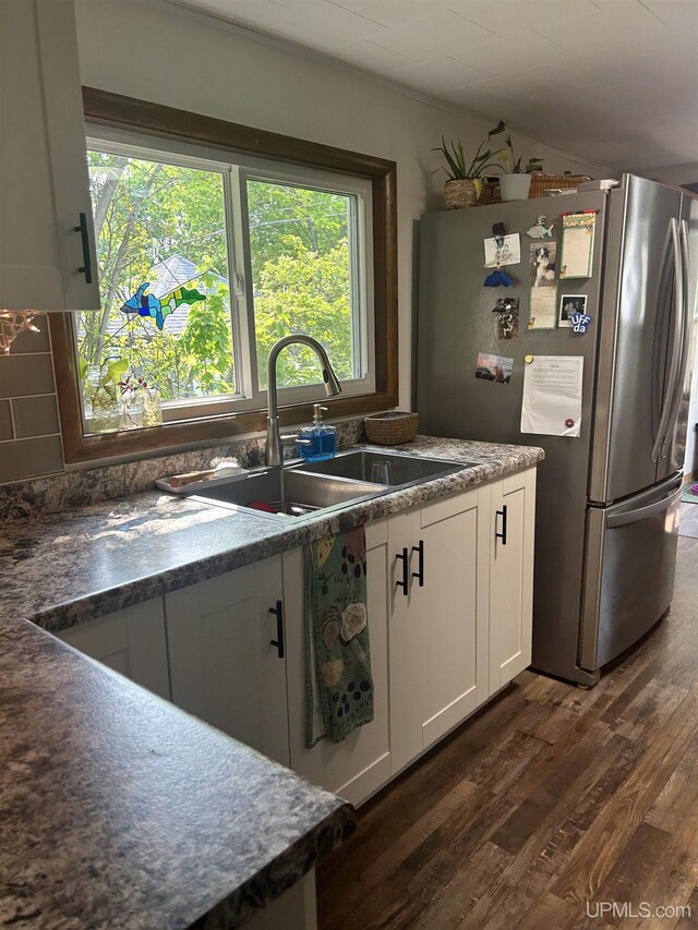 312 N Mckenzie Ave, Negaunee, MI 49866 - kitchen featuring freestanding refrigerator, a sink, dark wood-style floors, healthy amount of natural light, and lofted ceiling