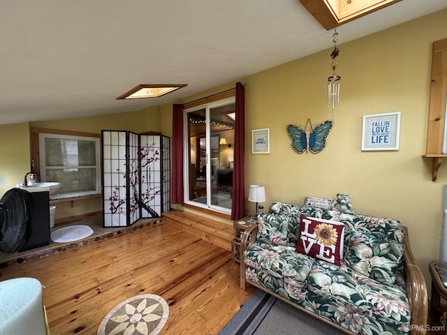 5452 W N Island Lake Rd, Hurley, WI 54534 - living room featuring a skylight, hardwood / wood-style flooring, and lofted ceiling
