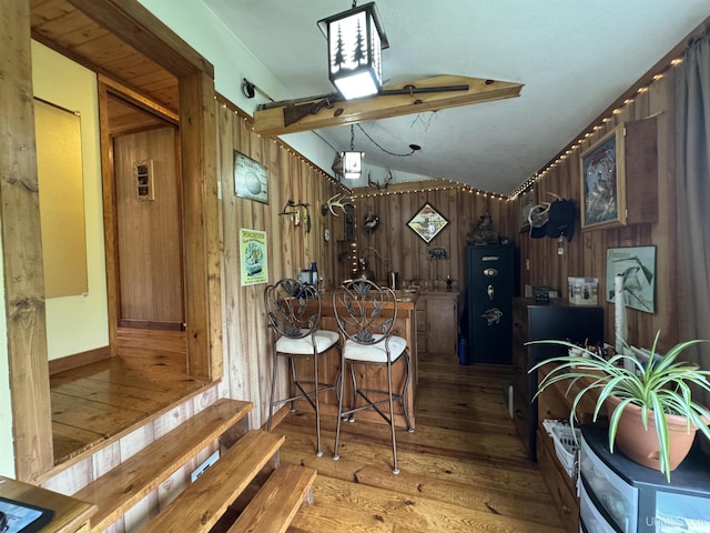 5452 W N Island Lake Rd, Hurley, WI 54534 - kitchen featuring wood walls, light wood finished floors, and lofted ceiling