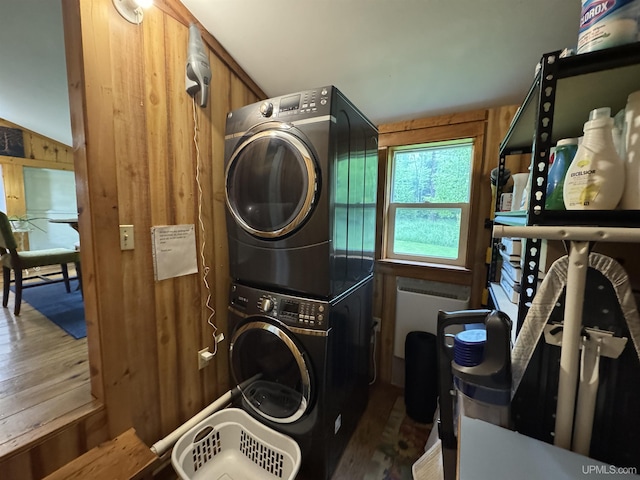 5452 W N Island Lake Rd, Hurley, WI 54534 - washroom with estacked washer and dryer, wood finished floors, wood walls, and radiator
