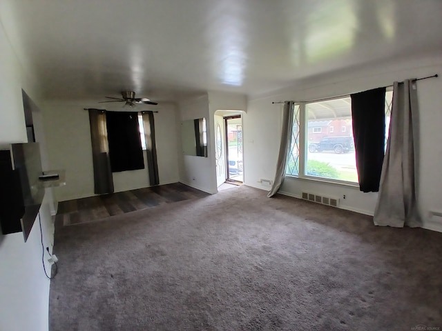 24675 Ridgecroft Ave, Eastpointe, MI 48021 - unfurnished living room with a ceiling fan, arched walkways, carpet flooring, and baseboards