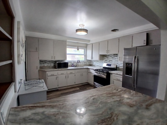 24675 Ridgecroft Ave, Eastpointe, MI 48021 - kitchen with appliances with stainless steel finishes, a sink, tasteful backsplash, and dark wood-style flooring