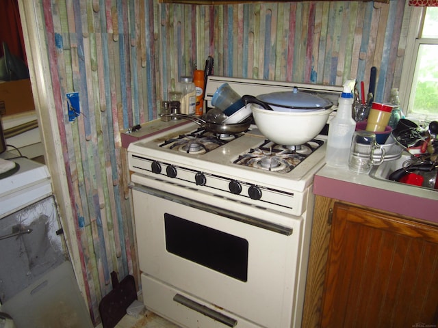 1984 E Marlette Rd, Applegate, MI 48401 - kitchen featuring white gas range and wallpapered walls