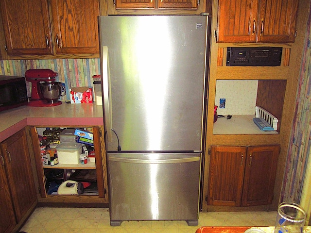 1984 E Marlette Rd, Applegate, MI 48401 - kitchen with freestanding refrigerator, black microwave, light countertops, light floors, and brown cabinets