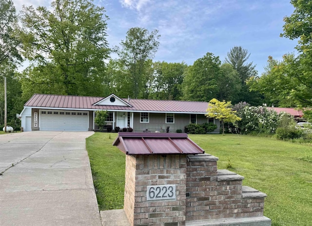 6223 E Townline Lake Rd, Harrison, MI 48625 - ranch-style home with a garage, a front lawn, driveway, metal roof, and board and batten siding