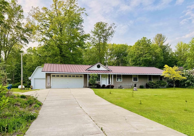 6223 E Townline Lake Rd, Harrison, MI 48625 - ranch-style house featuring board and batten siding, an attached garage, concrete driveway, and a front lawn