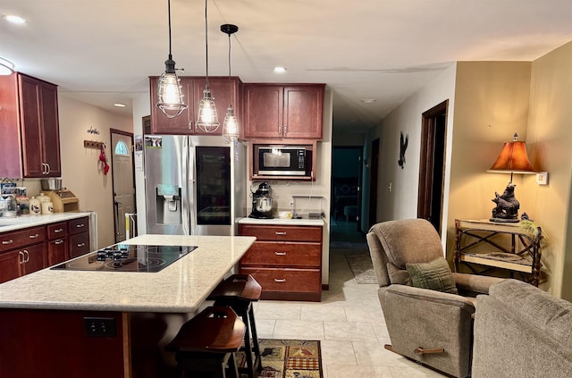 6223 E Townline Lake Rd, Harrison, MI 48625 - kitchen with appliances with stainless steel finishes, dark brown cabinets, open floor plan, recessed lighting, and pendant lighting