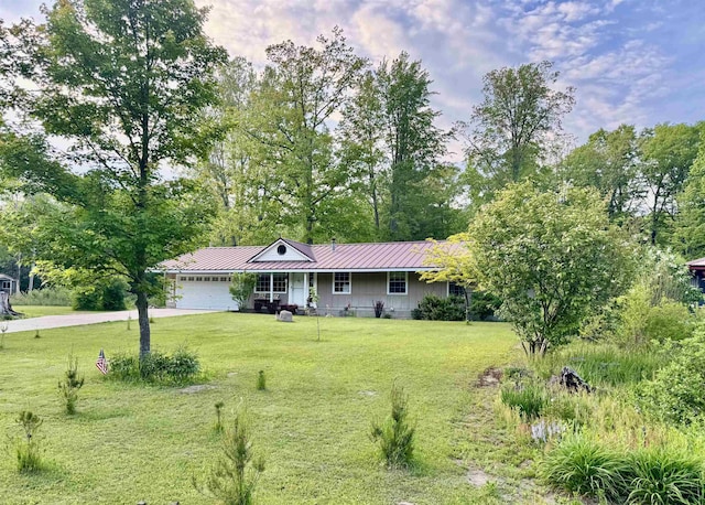 6223 E Townline Lake Rd, Harrison, MI 48625 - ranch-style house with an attached garage, a front lawn, concrete driveway, and metal roof