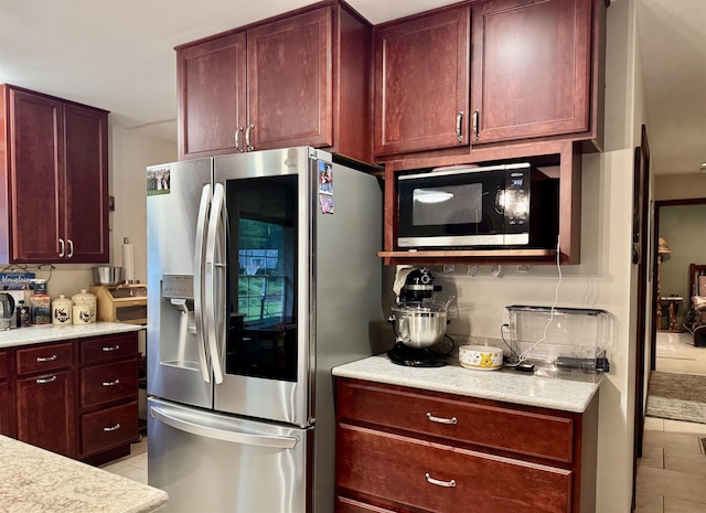 6223 E Townline Lake Rd, Harrison, MI 48625 - kitchen featuring stainless steel fridge, light tile patterned floors, and dark brown cabinets