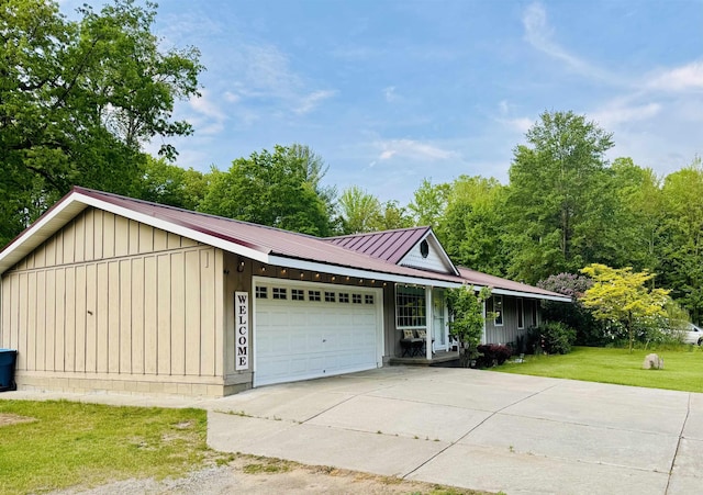 6223 E Townline Lake Rd, Harrison, MI 48625 - ranch-style home with board and batten siding, a garage, a front yard, concrete driveway, and metal roof