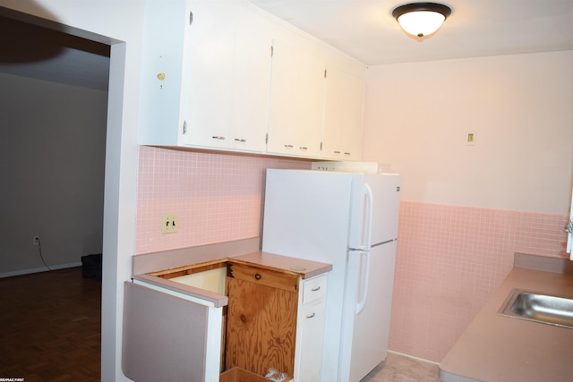 22800 Beaconsfield Ave, Eastpointe, MI 48021 - kitchen featuring tile walls, white cabinets, wainscoting, freestanding refrigerator, and light countertops