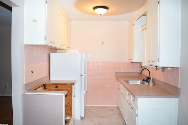 22800 Beaconsfield Ave, Eastpointe, MI 48021 - kitchen featuring a sink, freestanding refrigerator, tile walls, white cabinets, and light countertops